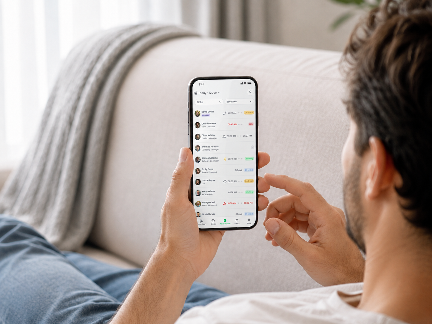A business owner checking team attendance in the Obecno mobile app.